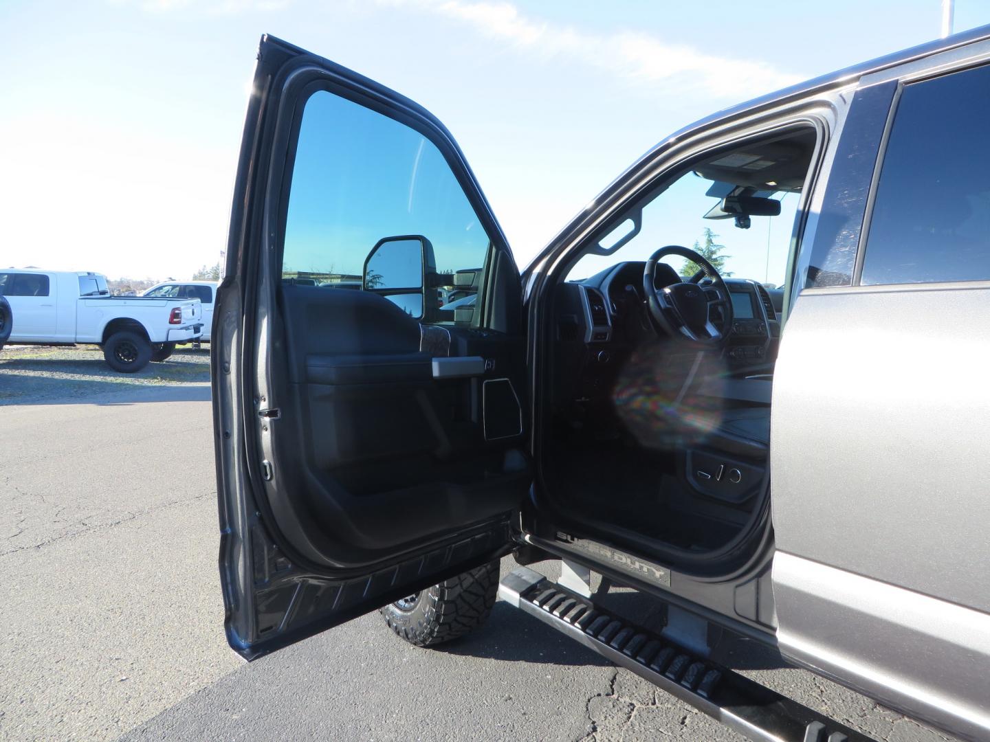 2019 CHARCOAL /BLACK Ford F-350 SD Lariat Crew Cab 4WD (1FT8W3BT7KE) with an 6.7L V8 OHV 16V DIESEL engine, 6A transmission, located at 2630 Grass Valley Highway, Auburn, CA, 95603, (530) 508-5100, 38.937893, -121.095482 - Leveled Superduty sitting on 20" XD series wheels, 35" Nitto Ridge Grappler tires, window tint, and has Firestone Air bags. - Photo#15